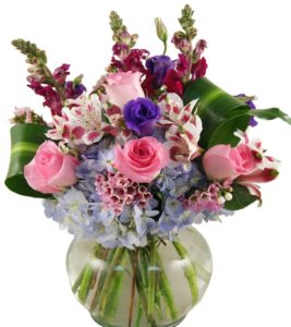 pink roses and lilies with greens in vase