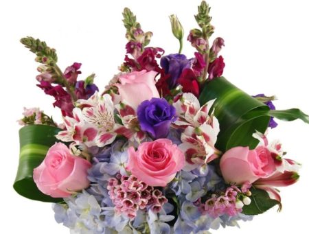 Our signature display of beautiful blue hydrangeas, pink roses, purple lisianthus, alstromerias, snapdragons and masangena leaves in an elegant glass vase.